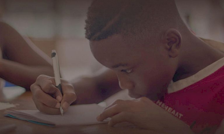 Children writing on desk