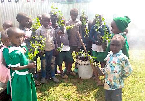 Children planting trees at our school